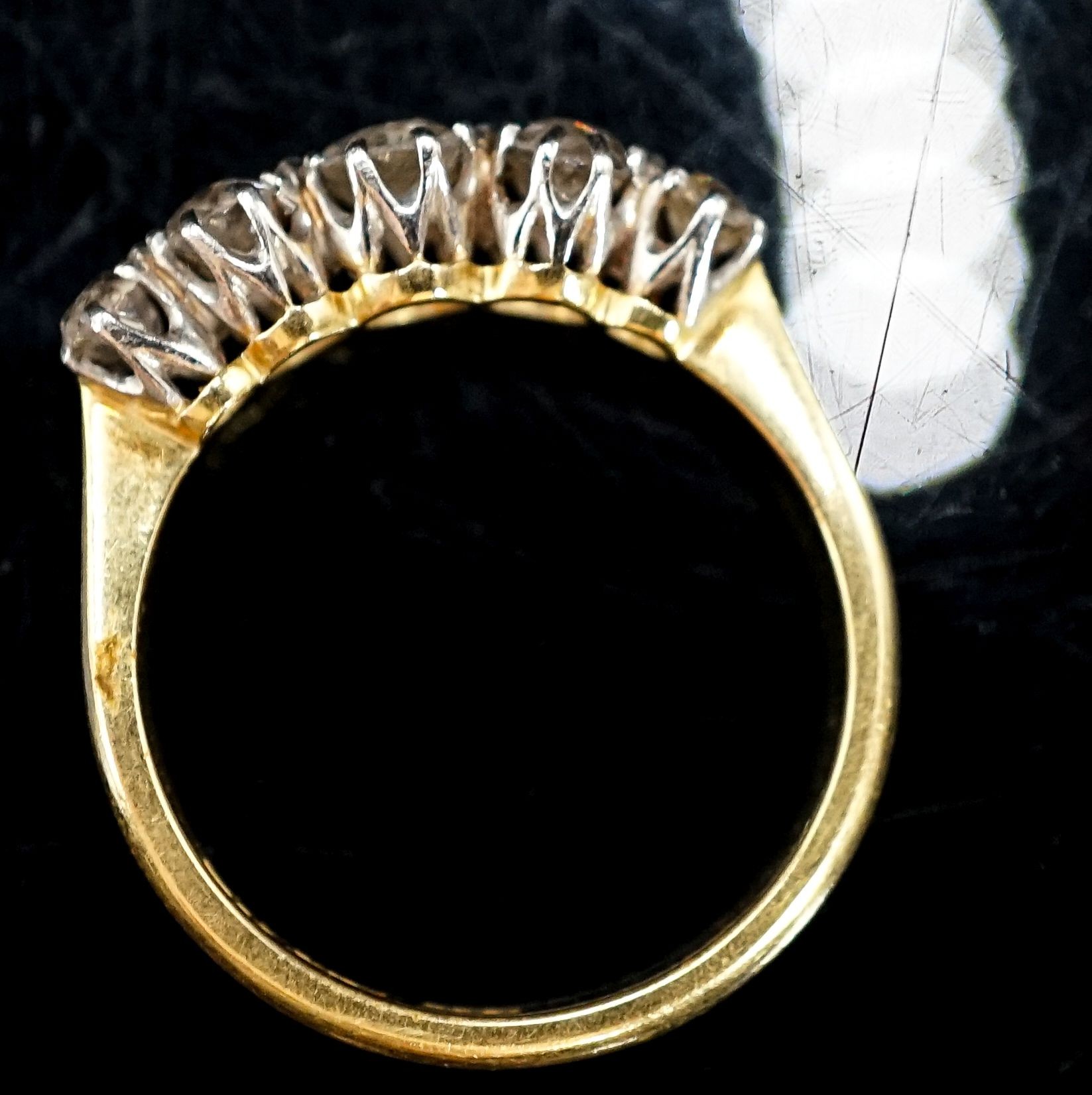 An 18ct, plat and graduated five stone diamond set half hoop ring, size N, gross 3.1 grams.